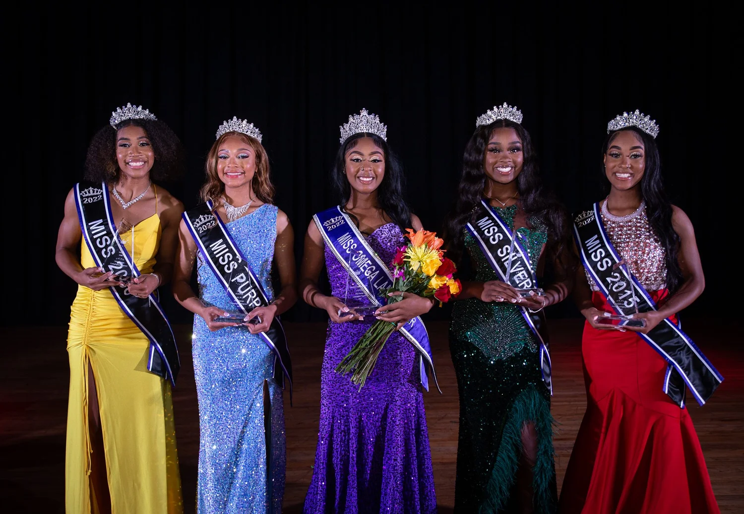 Pageant titleholders on a stage lit by RTA Productions